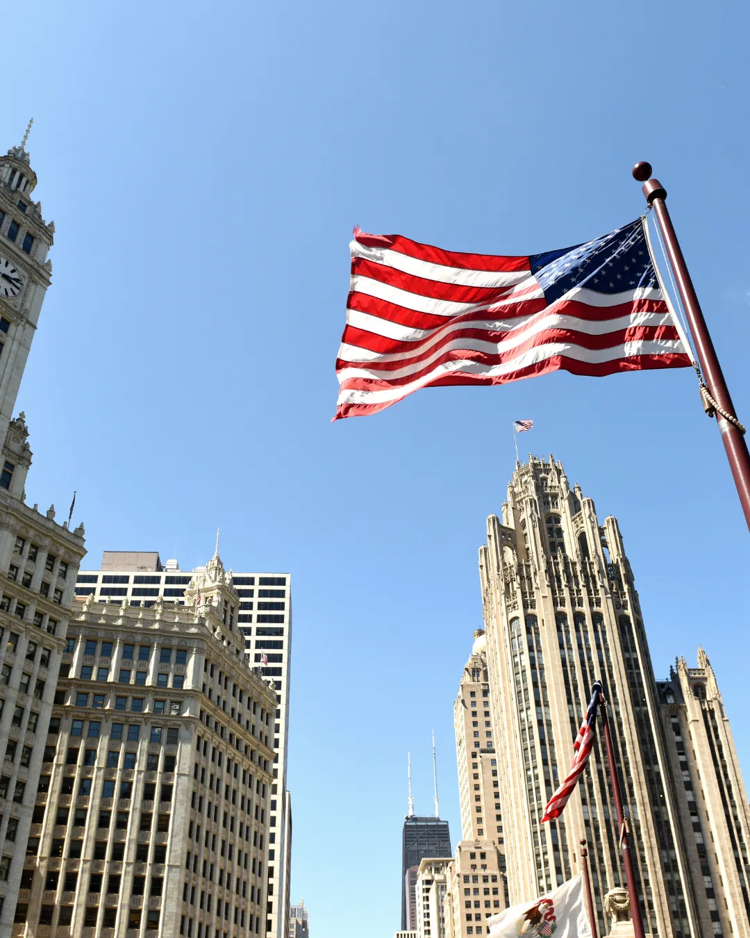 The US flag among city towers